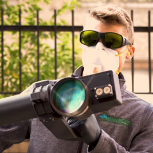 Man Holding Mobile Pulsed Laser Cleaning Device